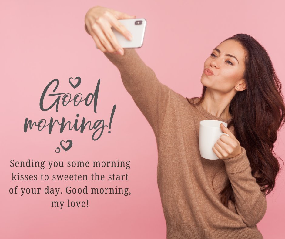 Young woman in a brown sweater taking a selfie while holding a white coffee mug, against a pink background with 'Good Morning!' text, ideal for sending Good Morning Sweet Messages for Him.