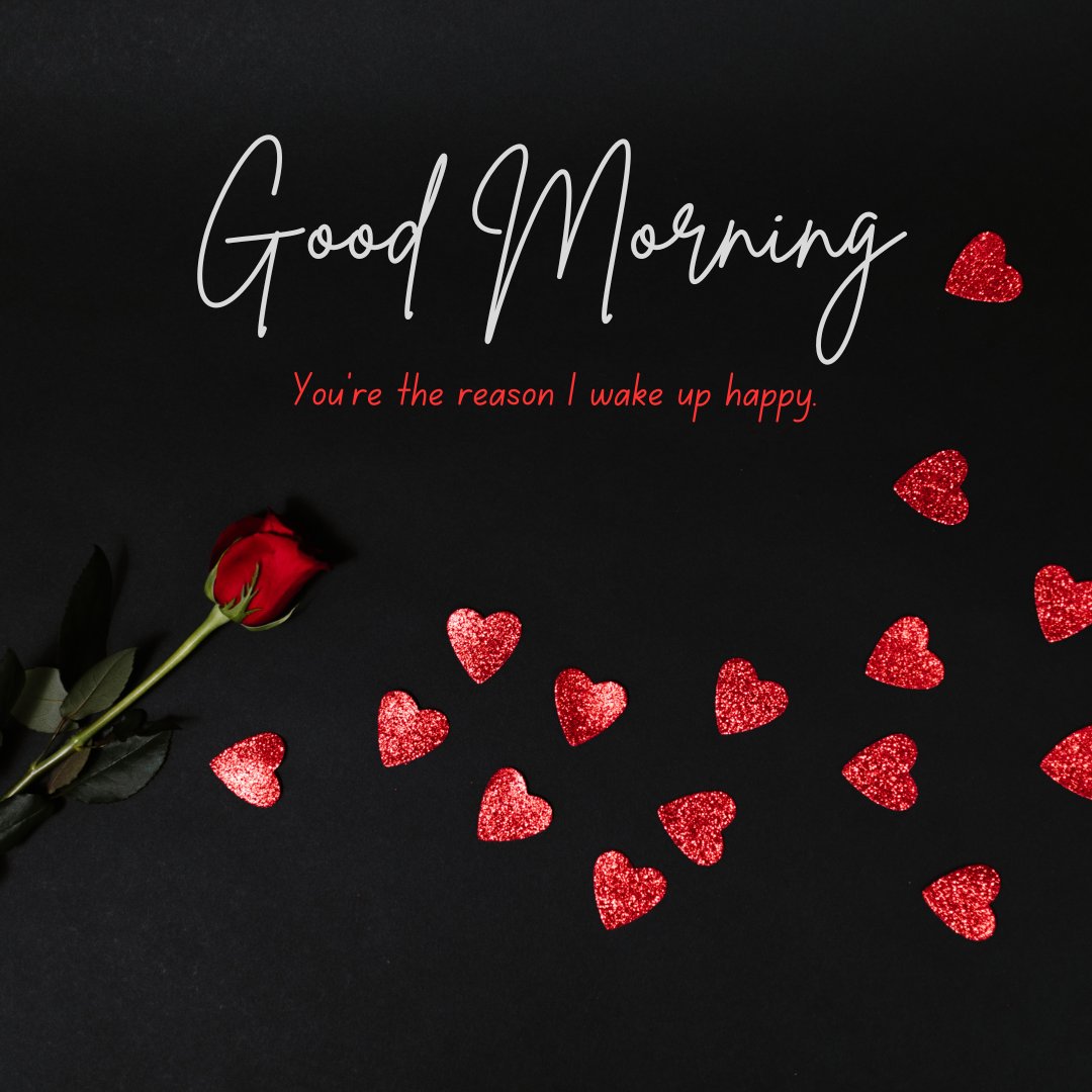 The Top Good Morning Texts For Girlfriend: A romantic setting with a single red rose and numerous red glittery hearts on a black background, alongside the message 'Good Morning. You're the reason I wake up happy.'